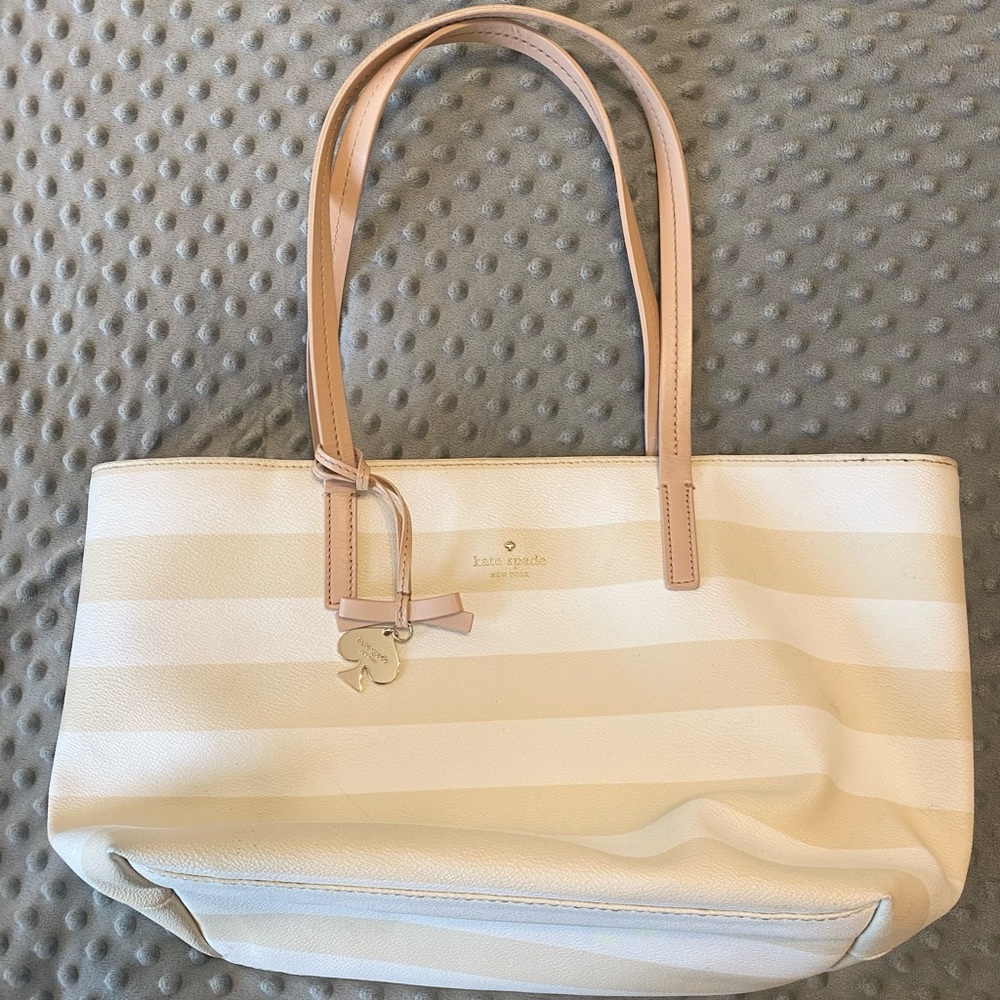 Kate Spade tote with cream and white bold stripes with nude straps, gold charm.